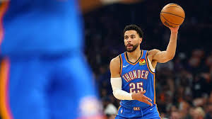 Apr 27, 2026; Phoenix, Arizona, USA; Oklahoma City Thunder guard Ajay Mitchell (25) against the Phoenix Suns during game four of the first round of the 2026 NBA Playoffs at Mortgage Matchup Center. Mandatory Credit: Mark J. Rebilas-Imagn Images | Mark J. Rebilas-Imagn Images