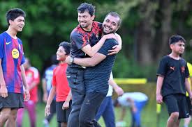 Sabuj Barua, of Medford, and Monir Mohammed, of Stoneham, celebrated a goal during an intergenerational pickup soccer game at Hickey Park in Medford on May 17.JOSH REYNOLDS FOR THE BOSTON