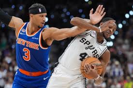 Knicks guard Josh Hart (3) pressures Spurs guard De’Aaron Fox (4) during the first half. Photograph: Eric Gay/AP